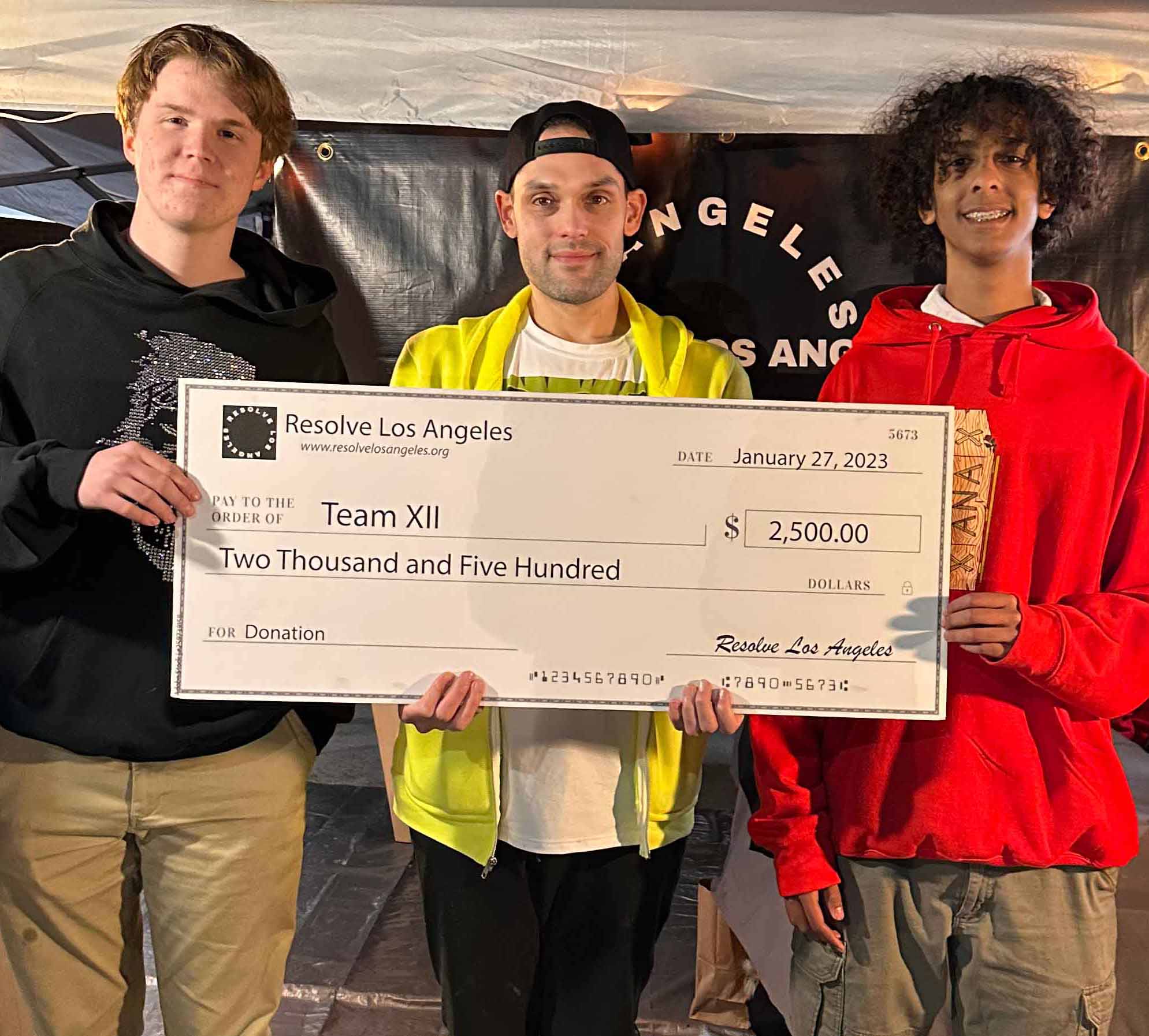 Resolve LA Team handing a $2,500 check to Team XII, a recovery nonprofit in Pasadena